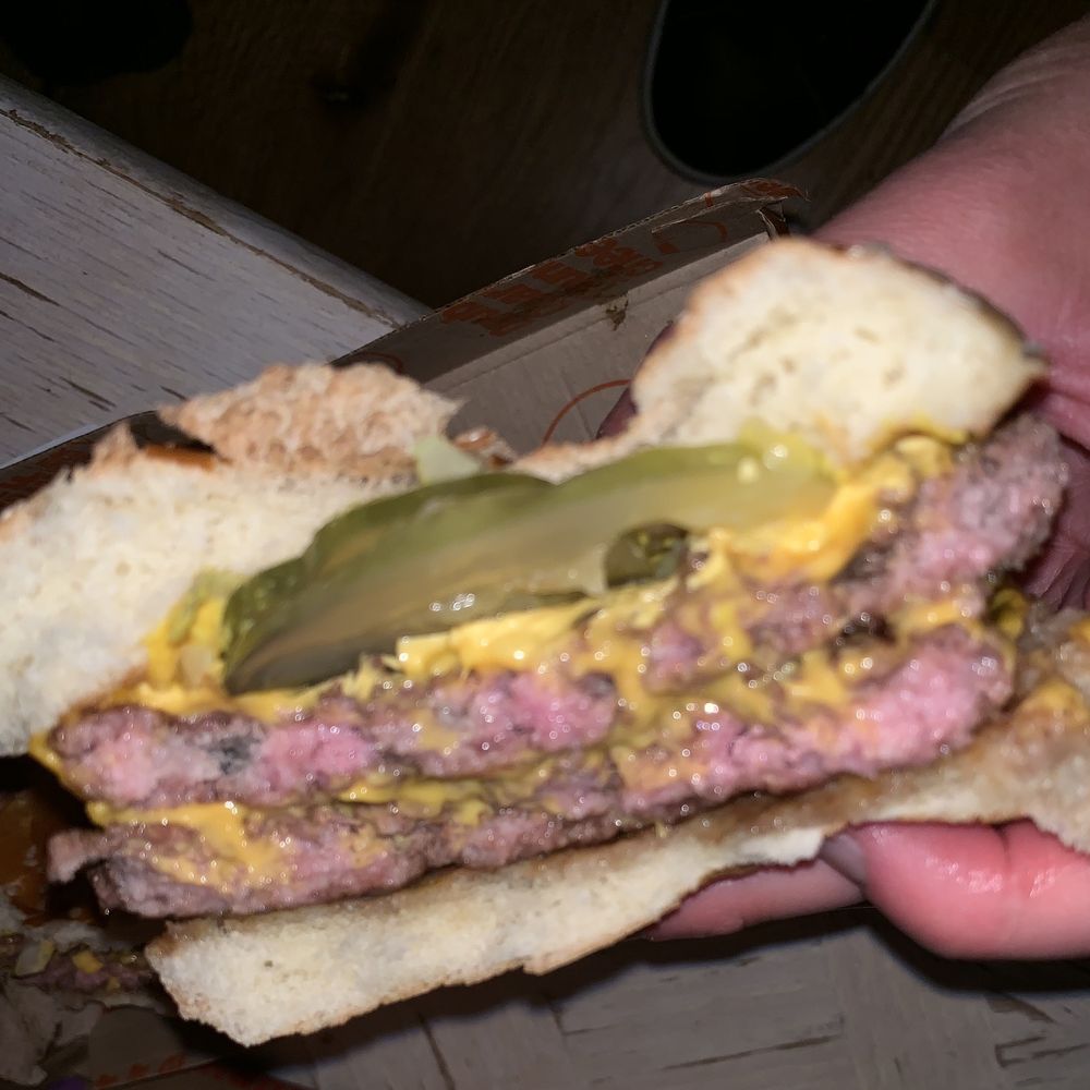 McDonald's - a hand holding a hamburger - Fast Food Near Me - Golden, Colorado