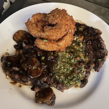 Moani Waikiki - Rib eye steak with onion rings. Boyfriend loved it but wished they cut out the fat, at least some of it. - Seafood Near Me - Honolulu, Hawaii