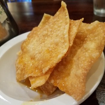 Hunsa Thai Kitchen - Complimentary fried wonton chips drizzled with spicy-sweet sauce. They're huge! - Thai Near Me - Seabrook, Texas Hunsa Thai Kitchen - Complimentary fried wonton chips drizzled with spicy-sweet sauce. They're huge! - Thai Near Me - Seabrook, Texas