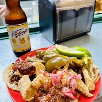 Carnitas Ramirez - Various tacos with toppings and a beer - Tacos Near Me - New York, New York