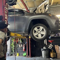 Monkey Wrench Inc - Jeep on a lift to get an oil change.