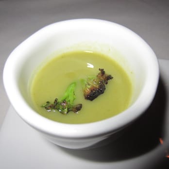 Bacchanalia - Sip of broccoli soup with broccoli floret. - New American Near Me - Atlanta, Georgia