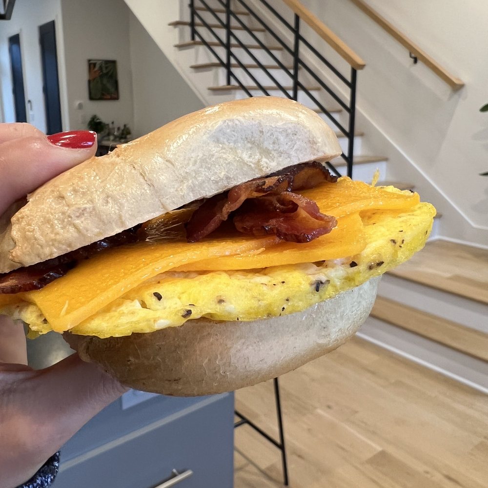 Chocolate Café Express - a hand holding a breakfast sandwich - Breakfast & Brunch Near Me - Columbus, Ohio