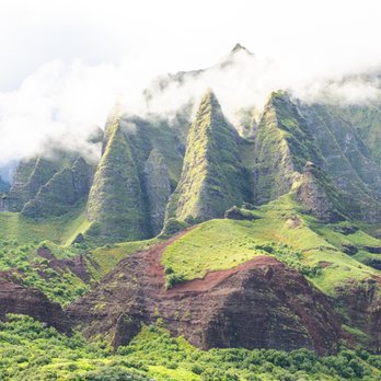 Kauai Sea Tours - Did you know "Pali" means sea cliffs? This photo is looking up at the lush Na Pali Coast and all its glory. Photographed by @fotopopkauai - Boating Near Me - Eleele, Hawaii