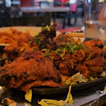 Masala Waves - Tandoori chicken on a super hot platter, steaming and sizzling. - Indian Near Me - Huntington Beach, California Masala Waves - Tandoori chicken on a super hot platter, steaming and sizzling. - Indian Near Me - Huntington Beach, California
