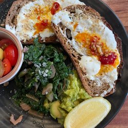Paramount Coffee Project - PCP Sydney Stracciatella, chilli & hazelnuts on rye, with heirloom toms, smashed avo & sautéed greens
