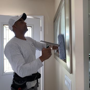Olaf's Window Cleaning - Window cleaning company cleaning the mirrors - Window Washing Near Me