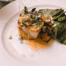 Petrale Sole on a white truffle risotto cake with braised greens Petrale Sole on a white truffle risotto cake with braised greens
