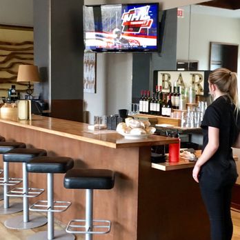 Lift Cafe - a woman standing at the bar - New American Near Me - Avon, Colorado