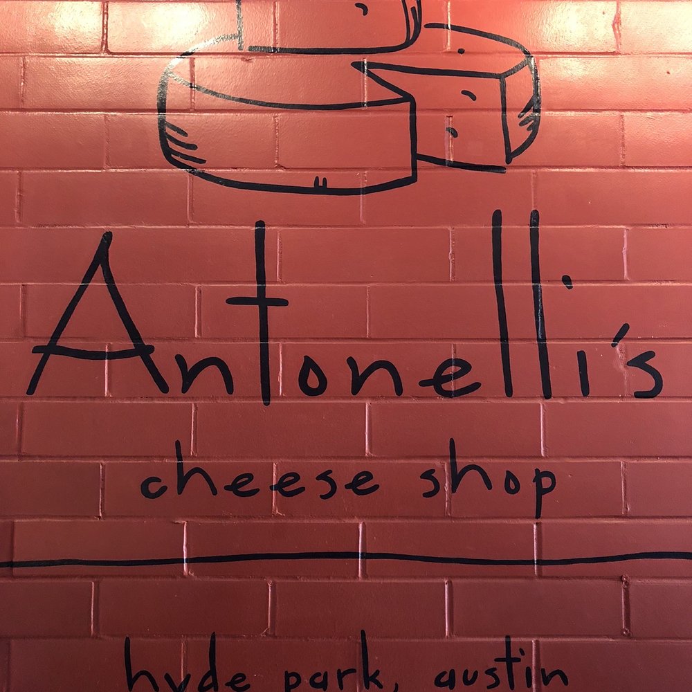 Antonelli's Cheese - Inside wall with logo. - Cheese Shops Near Me - Austin, Texas