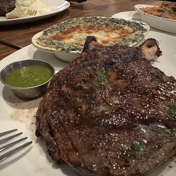 Stoney River - Creamed spinach, chimichurri, and a bone in ribeye steak - Steakhouses Near Me - Annapolis, Maryland Stoney River - Creamed spinach, chimichurri, and a bone in ribeye steak - Steakhouses Near Me - Annapolis, Maryland