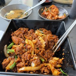 Spicy Pork Bulgogi Box with Miso Soup and Kimchiin the back. Spicy Pork Bulgogi Box with Miso Soup and Kimchiin the back.
