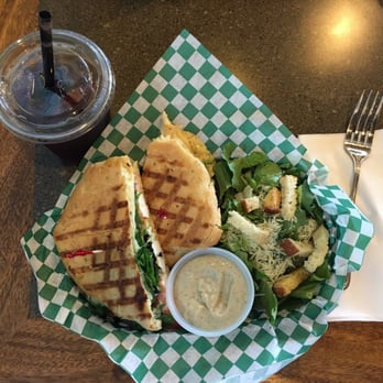 Artisan Bakery Cafe - The Mediterranean panini with a side Caesar salad and an iced tea. - Coffee & Tea Near Me - Medford, Oregon