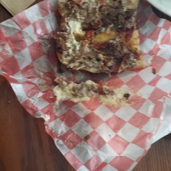 Tally-Ho Drive In - a piece of pizza on a table - American Near Me - Panama City, Florida Tally-Ho Drive In - a piece of pizza on a table - American Near Me - Panama City, Florida