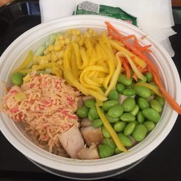 Bowl with brown rice, grilled chicken, spicy krab, mango, carrot, corn, and edamame. Bowl with brown rice, grilled chicken, spicy krab, mango, carrot, corn, and edamame.