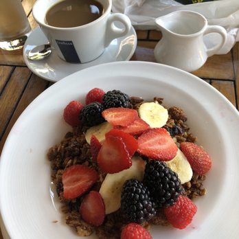 Tarallucci e Vino - Yoghurt with granola and berries, coffee with milk. - Italian Near Me - New York, New York Tarallucci e Vino - Yoghurt with granola and berries, coffee with milk. - Italian Near Me - New York, New York