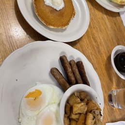 This is a sausage + egg combo that came with a stack of their thin pancakes. home fries also pictured. This is a sausage + egg combo that came with a stack of their thin pancakes. home fries also pictured.