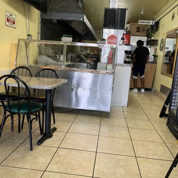 Tacos Y Pupusas - Small seating area 5 tables total - walk up to order at the counter- drinks in a cooler - Salvadoran Near Me - Anaheim, California Tacos Y Pupusas - Small seating area 5 tables total - walk up to order at the counter- drinks in a cooler - Salvadoran Near Me - Anaheim, California