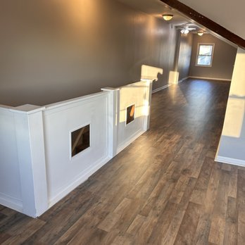 Sleek Renovations - a living room with hardwood floors and a fireplace - General Contractors Near Me Sleek Renovations - a living room with hardwood floors and a fireplace - General Contractors Near Me