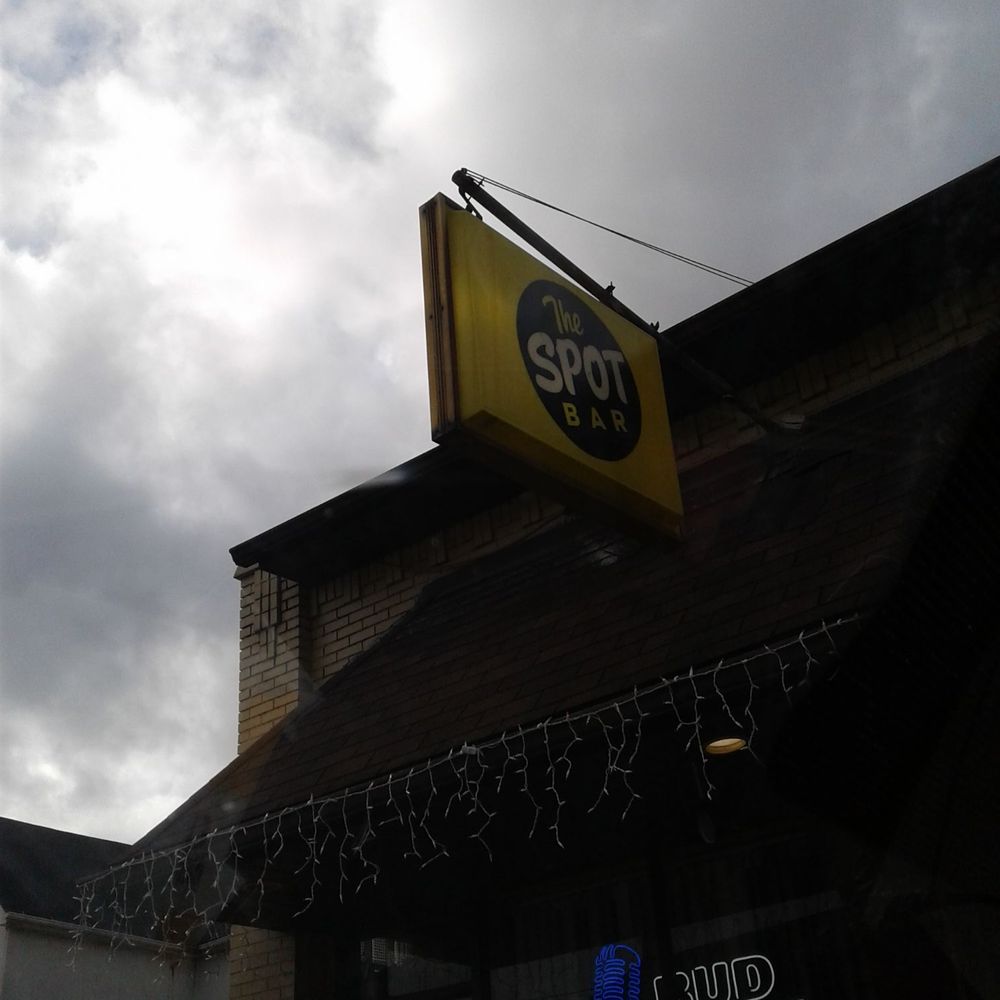Spot Bar - a yellow sign hanging from the side of a building - Bars Near Me - Steubenville, Ohio Spot Bar - a yellow sign hanging from the side of a building - Bars Near Me - Steubenville, Ohio