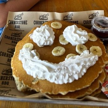 Cornerstone BBQ Redlands - Pancakes with banana, whipped cream and syrup. They saw we had kids with us so they made the whip into a happy face - Barbeque Near Me - Redlands, California Cornerstone BBQ Redlands - Pancakes with banana, whipped cream and syrup. They saw we had kids with us so they made the whip into a happy face - Barbeque Near Me - Redlands, California