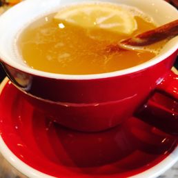Hot toddy served with lemon and cinnamon stick
