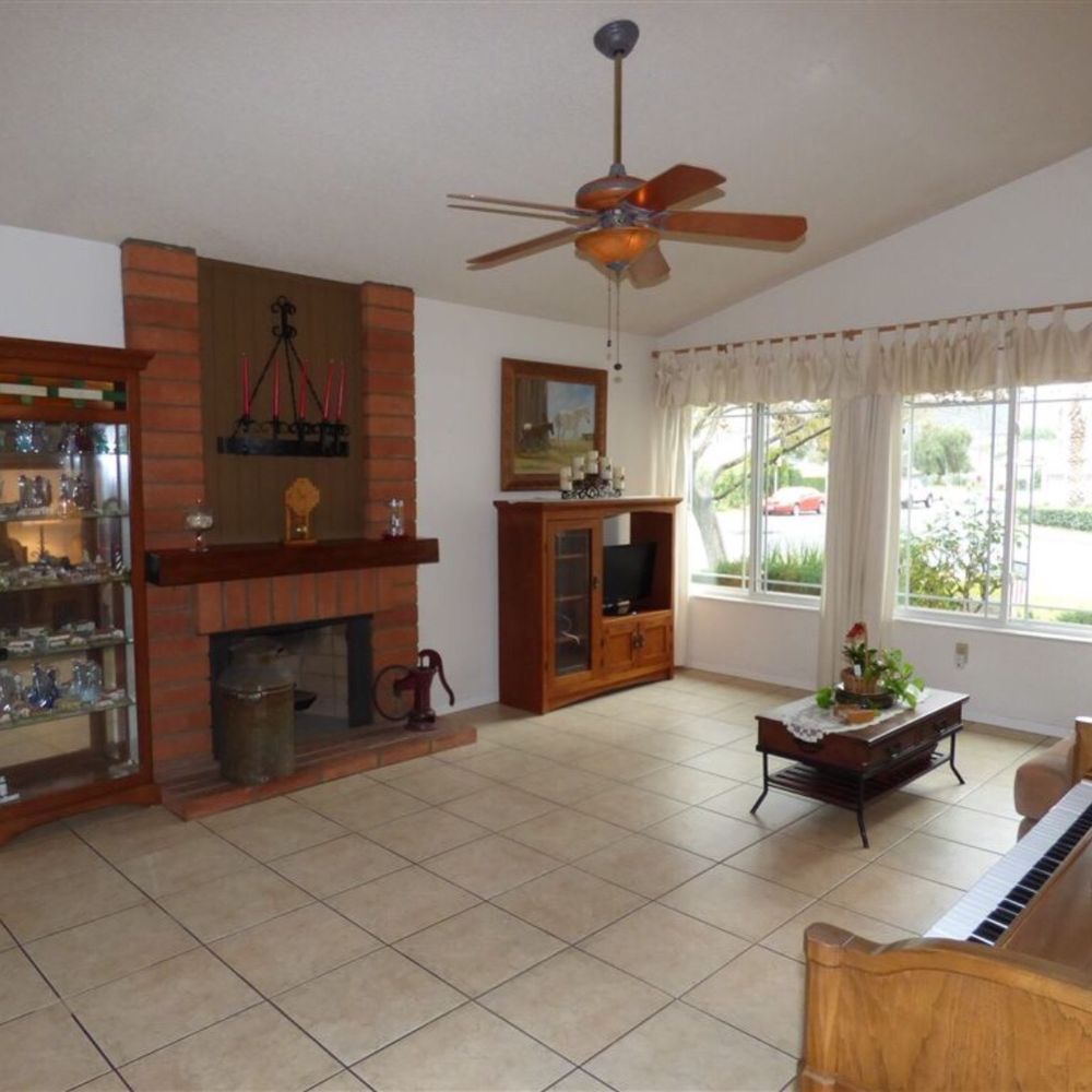 Rainbow Painting Consulting - Before - Living room and brick fireplace - Painters Near Me Rainbow Painting Consulting - Before - Living room and brick fireplace - Painters Near Me
