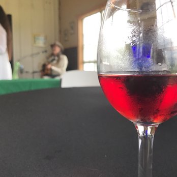 Windy Winery - a glass of red wine on a table - Wineries Near Me - Brenham, Texas Windy Winery - a glass of red wine on a table - Wineries Near Me - Brenham, Texas