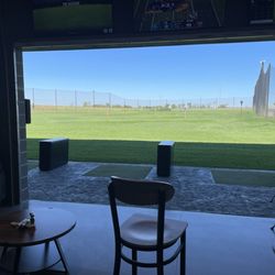 The Rustick Golf & Fare - Rented Bay with tables and a server.