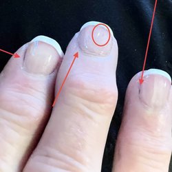 Fashion Nails - French manicure over a darker polish that was not removed by the manicurist.
