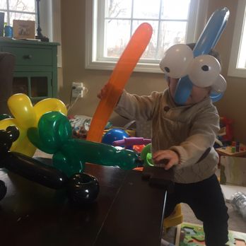 Boston Balloon Twisting - A dolphin hat, a sword, motorcycle and flower - Party Equipment Rentals Near Me