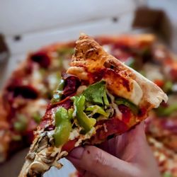 Regino's Pizza - Pizza slice. It's a large pepperoni, mushrooms, and green peppers pizza.