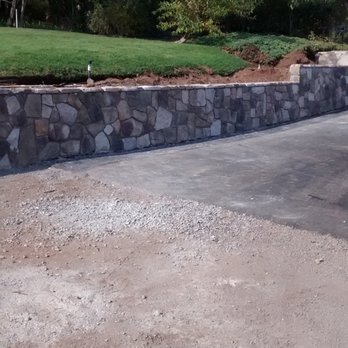 Ramco - a paved driveway with a retaining wall - General Contractors Near Me Ramco - a paved driveway with a retaining wall - General Contractors Near Me