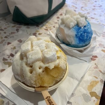 Ululani's - Passion fruit, Mango and Coconut with snow cap topping and mochi (Left). Blue raspberry, Coconut and Calamansi with mochi (Right). - Shaved Ice Near Me - Chula Vista, California