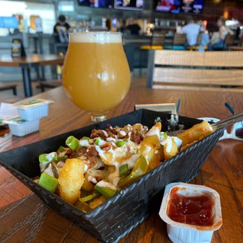 Flix Brewhouse - Loaded french fries and Nebulas draft. - Breweries Near Me - Oklahoma City, Oklahoma