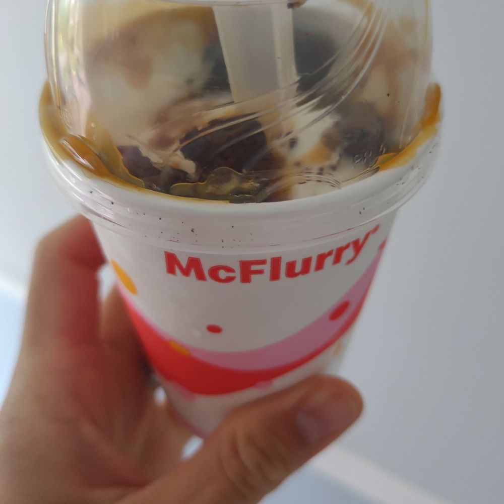 a hand holding a cup of ice cream a hand holding a cup of ice cream