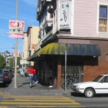 El Trebol Bar No 3 - a white car parked in front of a building - Dive Bars Near Me - San Francisco, California