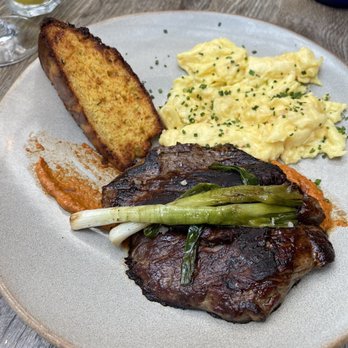 NOMO Kitchen - Brunch Steak & Eggs Hanger Steak, Breakfast Potatoes, Spring Onions, Chimichurri - New American Near Me - New York, New York
