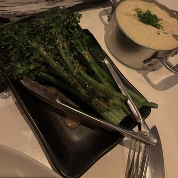 Stripsteak - Charred Broccolini and mashed potatoes with chives and butter. - Steakhouses Near Me - Honolulu, Hawaii Stripsteak - Charred Broccolini and mashed potatoes with chives and butter. - Steakhouses Near Me - Honolulu, Hawaii