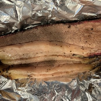 Roegels Barbecue Katy - Sliced brisket that hasn't had the fat rendered anywhere nearly well enough. It should not be so opaque--gross. - Barbeque Near Me - Katy, Texas Roegels Barbecue Katy - Sliced brisket that hasn't had the fat rendered anywhere nearly well enough. It should not be so opaque--gross. - Barbeque Near Me - Katy, Texas
