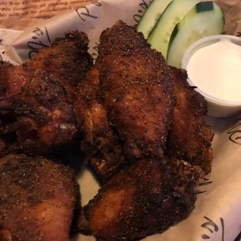 PJ's Smoke & Grill - Plate of fried chicken wings with a side of cucumber slices and a small container of dipping sauce. - Barbeque Near Me - Medway, Massachusetts