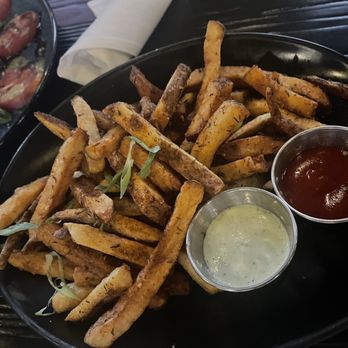 The Bellwether - Jerk Fries (enough to share). Vegan when you don't eat that white sauce (it's yogurt-based) - Cocktail Bars Near Me - St. Louis, Missouri The Bellwether - Jerk Fries (enough to share). Vegan when you don't eat that white sauce (it's yogurt-based) - Cocktail Bars Near Me - St. Louis, Missouri