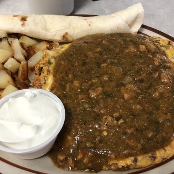 Hidden Cafe - a plate of food with a burrito, potatoes, and sour cream - Diners Near Me - Longmont, Colorado