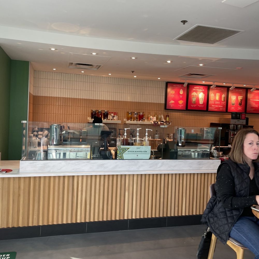 a woman sitting at a table in a coffee shop a woman sitting at a table in a coffee shop