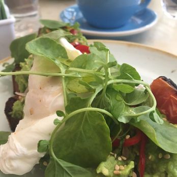 Two Hands - Avocado toast ($12) with poached egg ($3) and roasted tomato ($3) - Breakfast & Brunch Near Me - New York, New York Two Hands - Avocado toast ($12) with poached egg ($3) and roasted tomato ($3) - Breakfast & Brunch Near Me - New York, New York
