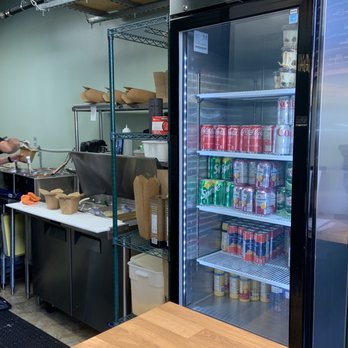 Via Pasta - a man preparing food in a commercial kitchen - Italian Near Me - Vancouver, British Columbia