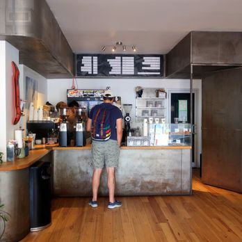 Sam James Coffee Bar - a man standing at the counter - Coffee & Tea Near Me - Toronto, Ontario Sam James Coffee Bar - a man standing at the counter - Coffee & Tea Near Me - Toronto, Ontario