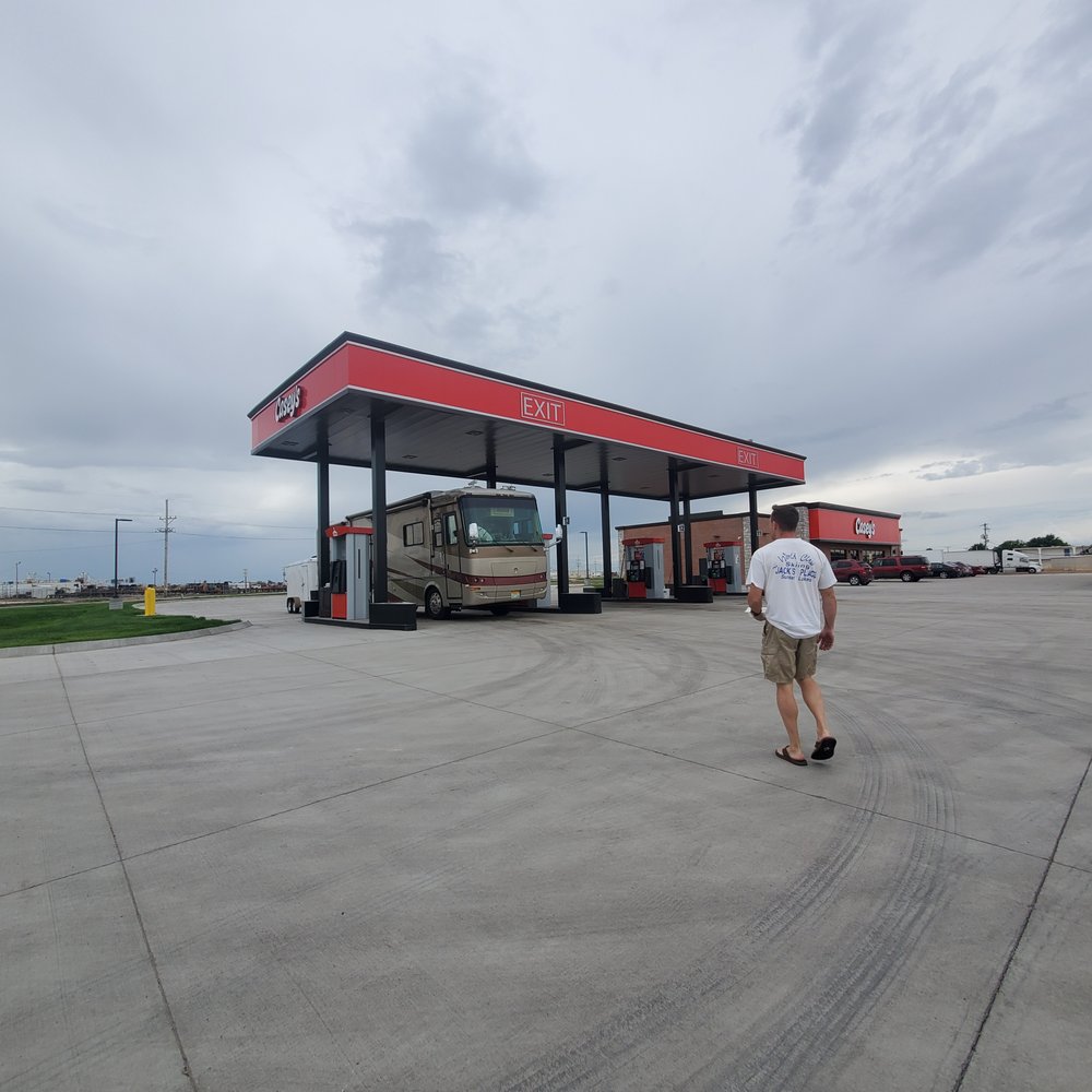 Casey's - a man walking in front of a gas station - Pizza Near Me - Hugoton, Kansas