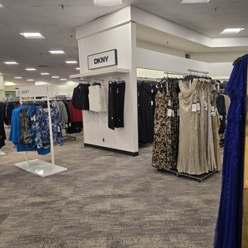 Macy's - Inside Macy's in Carlsbad, CA, clothing racks display dresses, tops, and pants, with a DKNY sign indicating the brand section. - Department Stores Near Me - Carlsbad, California