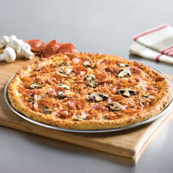 Domino's Pizza - a pizza on a cutting board - Pizza Near Me - Niagara Falls, Ontario Domino's Pizza - a pizza on a cutting board - Pizza Near Me - Niagara Falls, Ontario